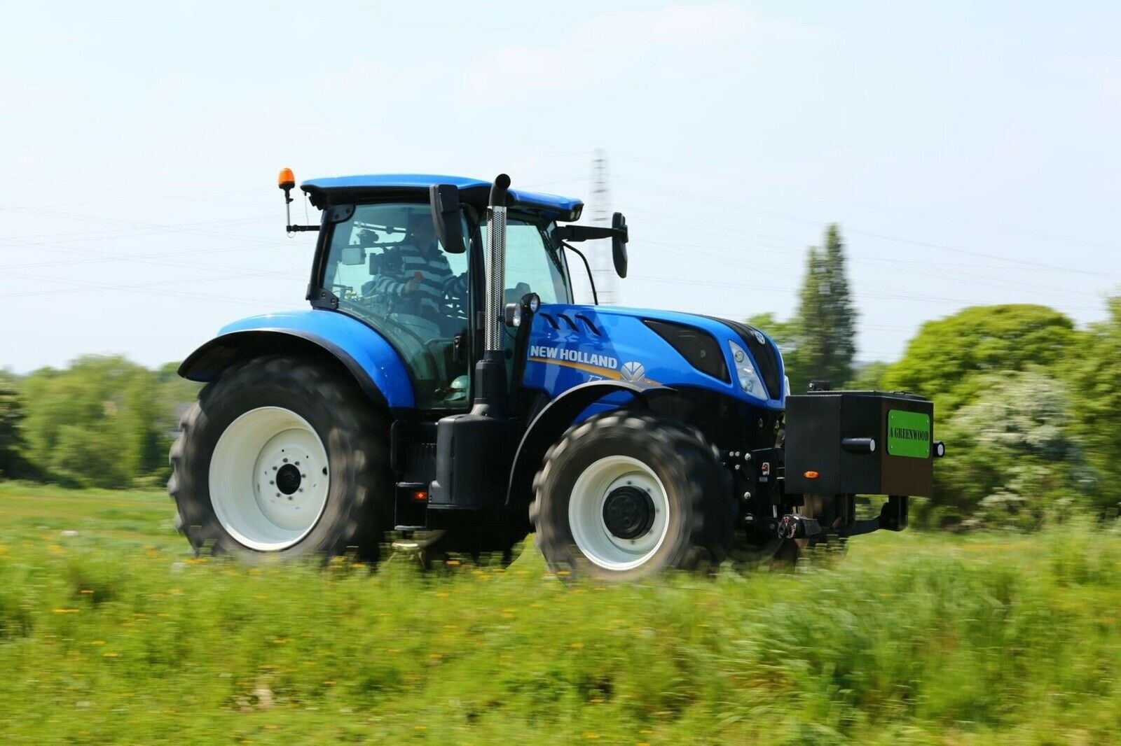 Stainless steel exhaust guard fitted to a blue tractor