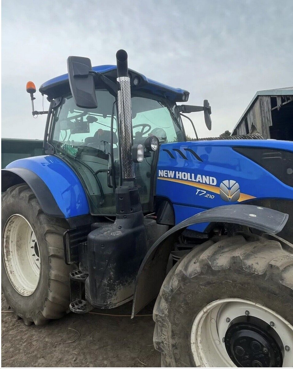 Stainless steel exhaust guard fitted to a New Holland tractor