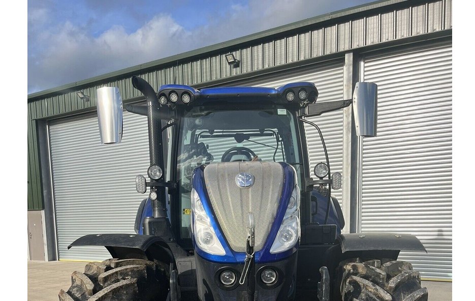 Pair of stainless steel mirror guards fitted to a tractor